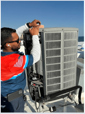 An experienced HVAC technician carefully servicing an outdoor air conditioning unit, ensuring optimal performance and and energy efficiency